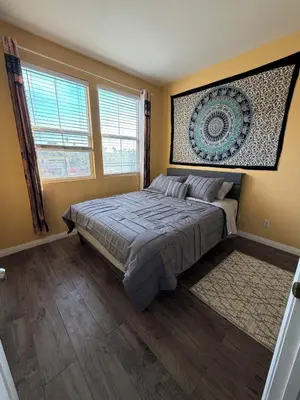 a bedroom with a bed and a painting on the wall at Private and Stylish 3Bdrm 3Ba Townhome, Gated Patio, King Bed, spacious in National City