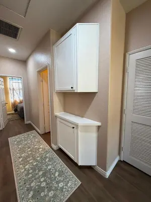 a kitchen with white cabinets and a rug at Private and Stylish 3Bdrm 3Ba Townhome, Gated Patio, King Bed, spacious in National City