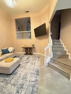 a living room with a couch and a tv at Private and Stylish 3Bdrm 3Ba Townhome, Gated Patio, King Bed, spacious in National City
