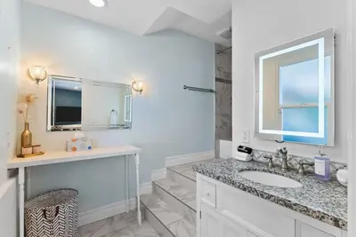 a white bathroom with a sink and a window at Sunset Summit by Coastline Vacation Rentals in La Mesa