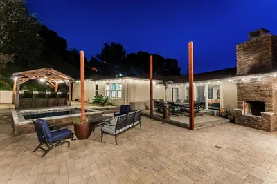 a backyard with a fireplace and a patio at Sunset Summit by Coastline Vacation Rentals in La Mesa