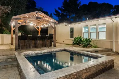 a swimming pool with a pergola and a house at Sunset Summit by Coastline Vacation Rentals in La Mesa