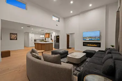 a living room with a couch and a fireplace at Spacious Modern Home with Rooftop & Private Backyard in Oceanside