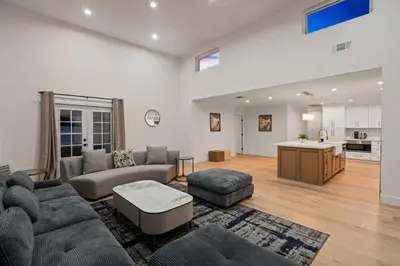 a living room with a couch and a table at Spacious Modern Home with Rooftop & Private Backyard in Oceanside