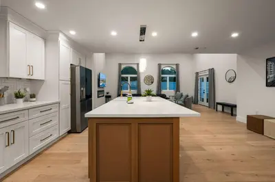 a kitchen with a island in the middle of it at Spacious Modern Home with Rooftop & Private Backyard in Oceanside