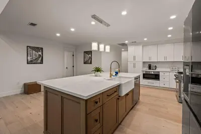a large kitchen with a large white counter top at Spacious Modern Home with Rooftop & Private Backyard in Oceanside