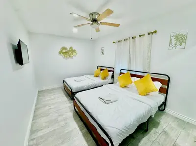 two beds in a room with a ceiling fan at Uniktrend Campo Rd Home by SD Stay in Spring Valley