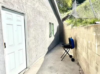 a blue chair sitting next to a wall next to a door at Uniktrend Campo Rd Home by SD Stay in Spring Valley