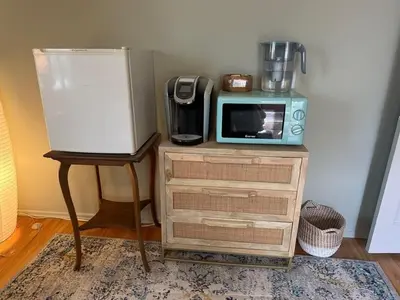 a microwave sitting on top of a dresser next to a table at 2BR Cozy Quiet Getaway, Great Mattress in El Cajon