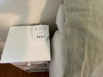 a white alarm clock sitting next to a bed at 2BR Cozy Quiet Getaway, Great Mattress in El Cajon