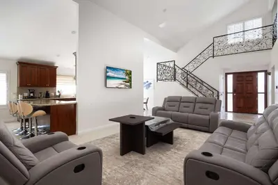 a living room with two couches and a kitchen at Spacious Central Home Villa in San Diego