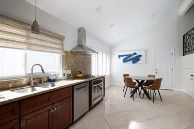 a kitchen with a sink and a table with chairs at Spacious Central Home Villa in San Diego