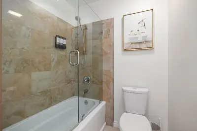 a bathroom with a shower and a toilet and a sink at Spacious Central Home Villa in San Diego