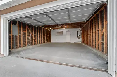an empty garage with wood paneled walls at Entire Private Home with 3 Bedrooms 2 Bathrooms, Gated Yard, Garage, Hot Tub, 4-Beds, Golf, Mira Mesa, Available Now in San Diego