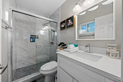 a bathroom with a shower and a toilet and a sink at Entire Private Home with 3 Bedrooms 2 Bathrooms, Gated Yard, Garage, Hot Tub, 4-Beds, Golf, Mira Mesa, Available Now in San Diego