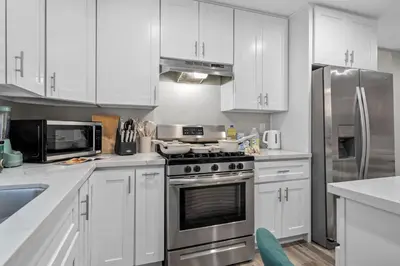 a kitchen with white cabinets and stainless steel appliances at Entire Private Home with 3 Bedrooms 2 Bathrooms, Gated Yard, Garage, Hot Tub, 4-Beds, Golf, Mira Mesa, Available Now in San Diego