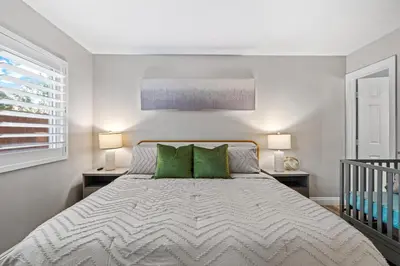 a bedroom with a large bed with green pillows at Entire Private Home with 3 Bedrooms 2 Bathrooms, Gated Yard, Garage, Hot Tub, 4-Beds, Golf, Mira Mesa, Available Now in San Diego