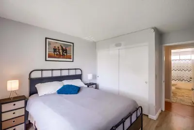 a bedroom with a bed with a blue pillow on it at Entire Private Home with 3 Bedrooms 2 Bathrooms, Ranch Style w Gated Yard near Beach, Available Now in Imperial Beach