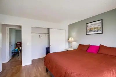 a bedroom with a large orange bed with pink pillows at Entire Private Home with 3 Bedrooms 2 Bathrooms, Ranch Style w Gated Yard near Beach, Available Now in Imperial Beach