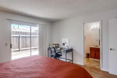 a bedroom with a bed and a desk and a window at Entire Private Home with 3 Bedrooms 2 Bathrooms, Ranch Style w Gated Yard near Beach, Available Now in Imperial Beach