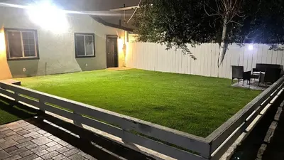 a backyard at night with a green lawn at 321 W Park El Cajon Front Unit by SD Stay in El Cajon
