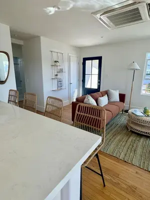 a living room with a couch and a table at South O Surf House by Coastline Vacation Rentals in Oceanside