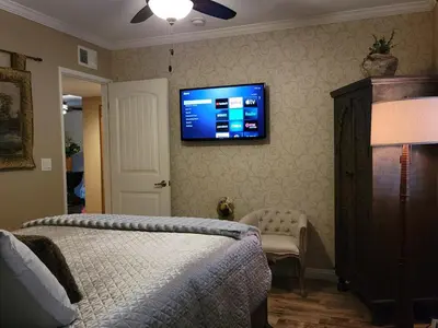 a bedroom with a bed and a flat screen tv on the wall at Outstanding condo with great amenities in La Mesa