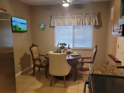 a kitchen with a table and chairs and a window at Outstanding condo with great amenities in La Mesa
