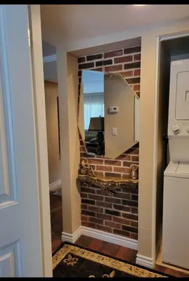 a room with a brick wall and a mirror at Outstanding condo with great amenities in La Mesa