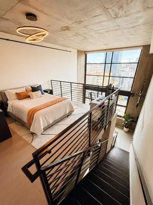 a bedroom with a bed on a balcony at Penthouse Industrial Loft & Parking Little Italy in San Diego