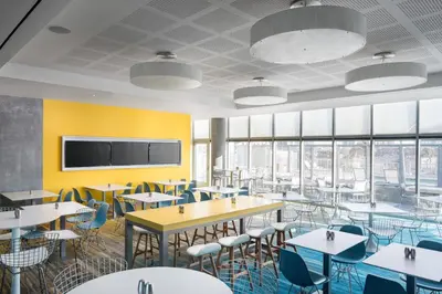 a dining room with tables and chairs and a tv at Residence Inn by Marriott San Diego Downtown/Bayfront in San Diego