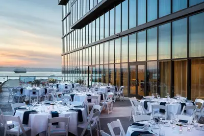 a restaurant with white tables and chairs and a building at Residence Inn by Marriott San Diego Downtown/Bayfront in San Diego