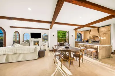 a kitchen and living room with a table and chairs at The Stratford - Del Mar Luxury Living in San Diego