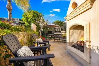 a patio with two chairs and a fireplace at The Stratford - Del Mar Luxury Living in San Diego