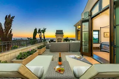 a house with a patio with a bottle of wine at The Stratford - Del Mar Luxury Living in San Diego