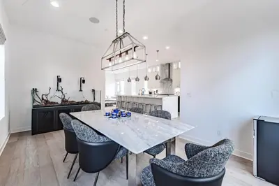 a kitchen and dining room with a table and chairs at #Marbella Lane - Luxurious Coastal Haven Escape in Newport Beach