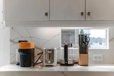 a kitchen counter with various appliances on a counter top at #Marbella Lane - Luxurious Coastal Haven Escape in Newport Beach