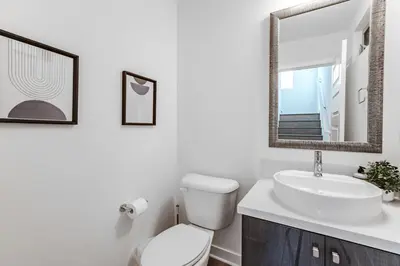 a bathroom with a toilet and a sink and a mirror at #Marbella Lane - Luxurious Coastal Haven Escape in Newport Beach