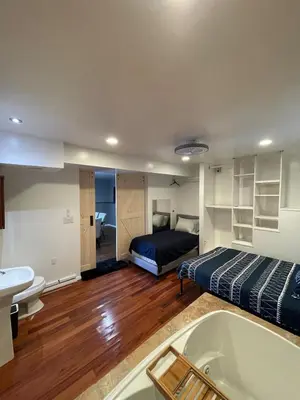 a bathroom with a bed and a tub in a room at Large Group getaway to all of San Diego's Best in La Mesa