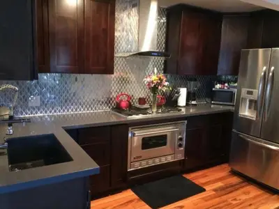 a kitchen with stainless steel appliances and wooden cabinets at Large Group getaway to all of San Diego's Best in La Mesa