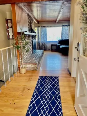 a living room with a blue and white mat on the floor at Large Group getaway to all of San Diego's Best in La Mesa