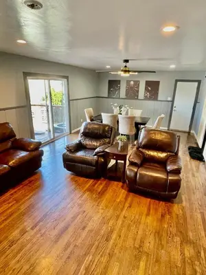 a living room with two leather chairs and a table at Large Group getaway to all of San Diego's Best in La Mesa