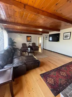 a large living room with a leather couch and chairs at Large Group getaway to all of San Diego's Best in La Mesa