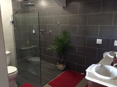 a bathroom with a shower and a toilet and a plant at Large Group getaway to all of San Diego's Best in La Mesa