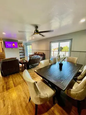a living room with a wooden table and chairs at Large Group getaway to all of San Diego's Best in La Mesa