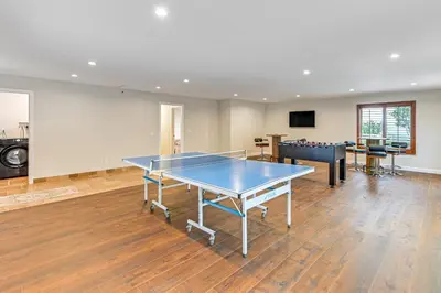 a ping pong table in the middle of a room at Game Room, Hot Tub and Views! Luxe Temecula Estate in Temecula