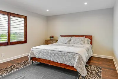 a bedroom with a bed and a window at Game Room, Hot Tub and Views! Luxe Temecula Estate in Temecula
