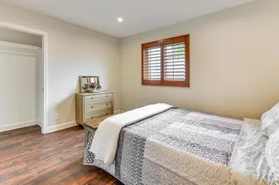 a bedroom with a bed and a dresser and a window at Game Room, Hot Tub and Views! Luxe Temecula Estate in Temecula