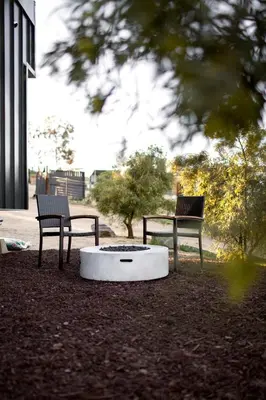 two benches and a fire pit in a park at Unplug in a Rustic-Chic Tiny Home: Stargazing Patio, Cookout Space & Nature Views in Aguanga, California in Aguanga