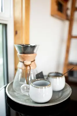 two coffee cups on a tray with a blender at Unplug in a Rustic-Chic Tiny Home: Stargazing Patio, Cookout Space & Nature Views in Aguanga, California in Aguanga